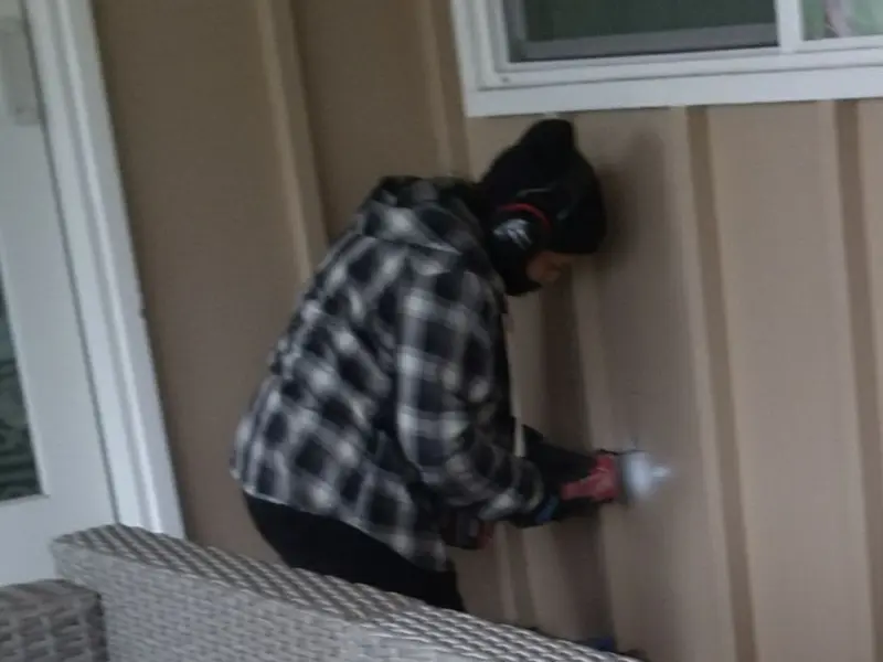 Professional electrician installing an exterior outlet in Welcome