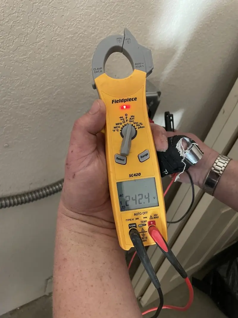 Voltage testing with clamp meter during Recessed Lighting Installation in Welcome